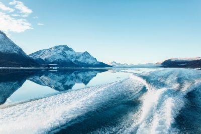 Boat Sailing On Clear Water On A Sunny Autumn Day In The Nuuk Fjord In Greenland