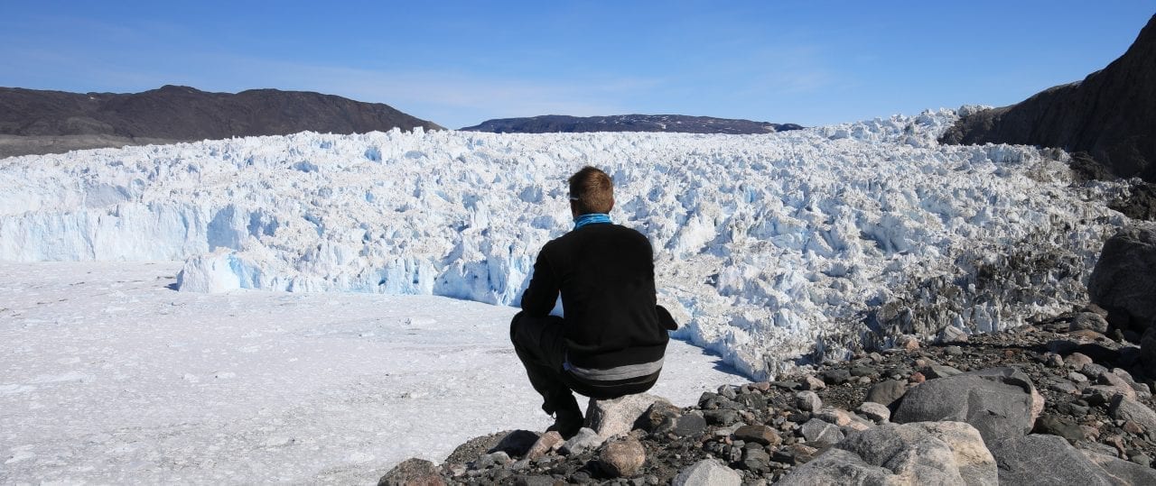 A guide enjoying the view of the Eqi Glacier